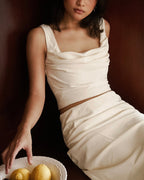 Woman in butter Nathanie odeon cowl neck top.